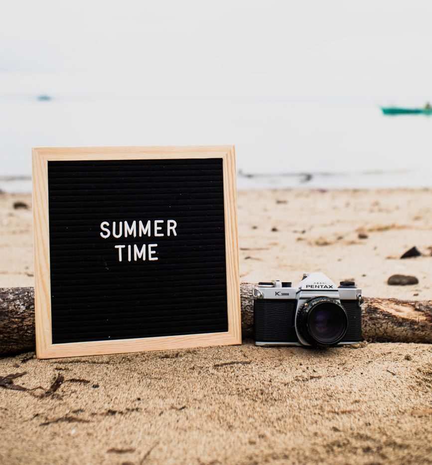 wooden frame and camera on brown sand